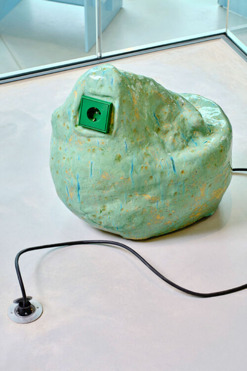 detail of a design object warm green glazed rock with a bright green jung socket by dutch invertuals for 5tracks interior design