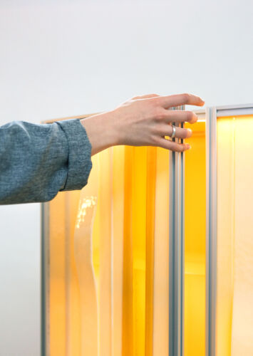 detail of butter honey yellow slumped glass cabinet with aluminium extrusion profile frame design by dutch invertuals