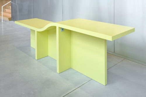 solid surface table with high and low side in bright yellow kerrock composite with grey socket design object by dutch invertuals